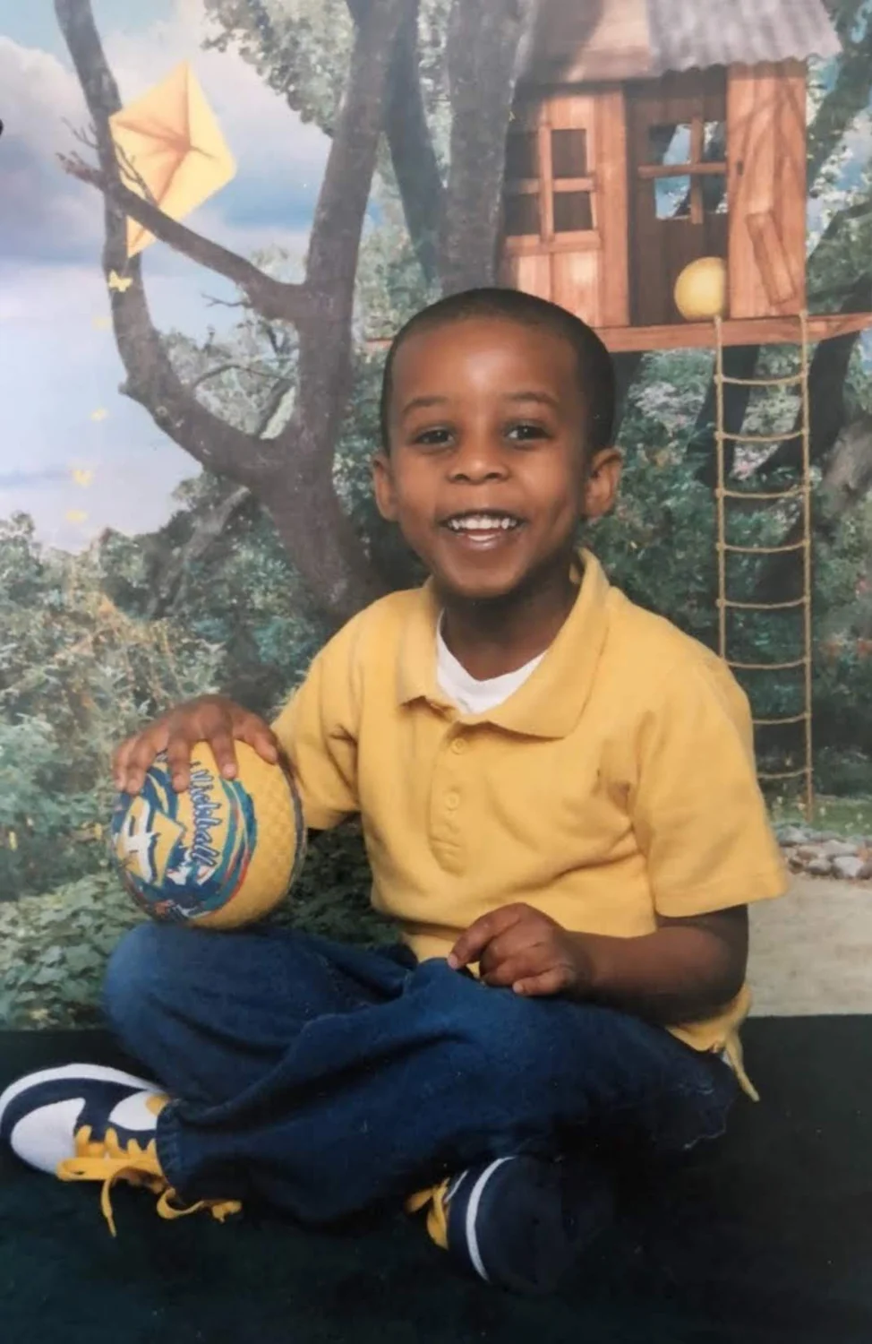 LJ Jackson as a child holding a basketball